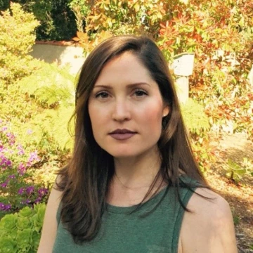portrait photo of woman with trees in background